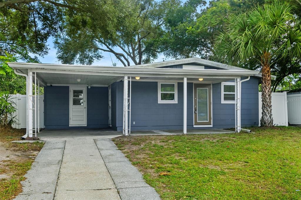 An aerial view shows a residential neighborhood with a red arrow pointing to a house — 4402 W TRILBY AVENUE, TAMPA, FL