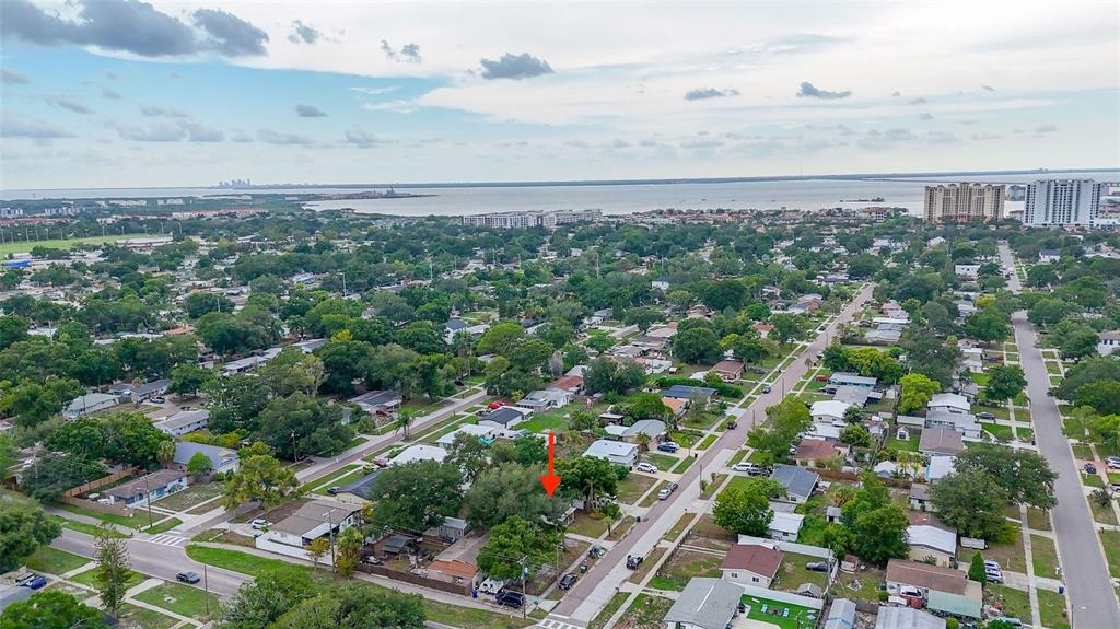 A kitchen with white cabinets, granite countertops, stainless steel appliances, and wood-look flooring — 4402 W TRILBY AVENUE, TAMPA, FL