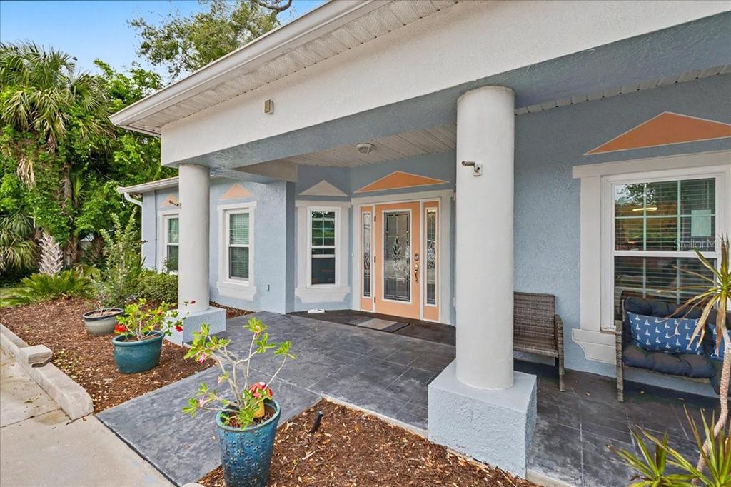 An aerial view shows a building with a parking lot on a corner lot — 1830 ORANGE TREE DRIVE, EDGEWATER, FL