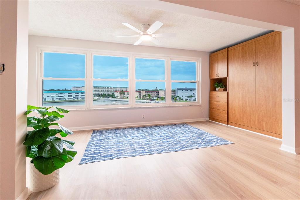 An open blue front door with a floral wreath leads into a residential unit — 5925 SHORE BOULEVARD S UNIT 405, GULFPORT, FL