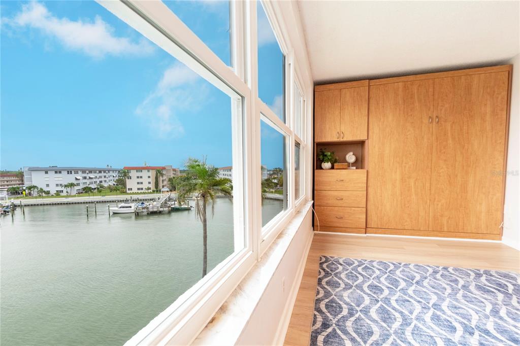 A blue front door with a floral wreath opens to a view of a building — 5925 SHORE BOULEVARD S UNIT 405, GULFPORT, FL