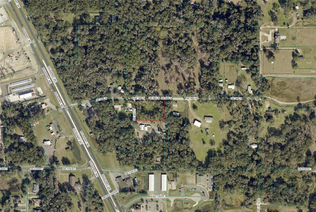 This is an aerial map view showing a residential property lot outlined in red — TBD SE 98TH LANE, BELLEVIEW, FL