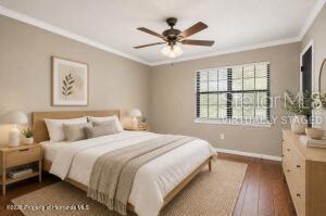 A bedroom features a bed, a ceiling fan, a dresser, and a window with blinds — 913 CANDLEBROOK LANE, BROOKSVILLE, FL