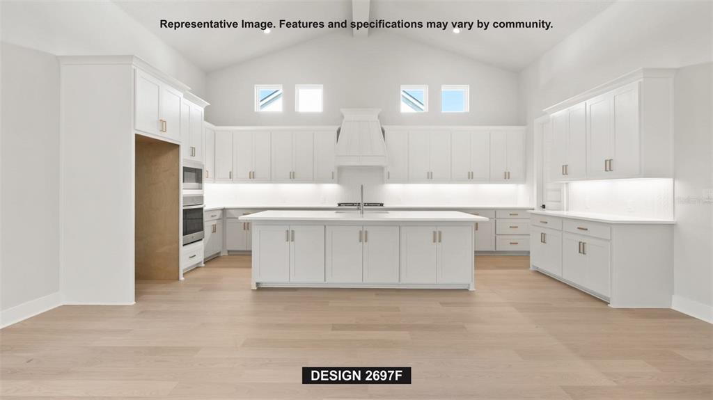 This rendering shows a modern white kitchen with a large island and vaulted ceilings — 4976 ELM LEAF DRIVE, BROOKSVILLE, FL