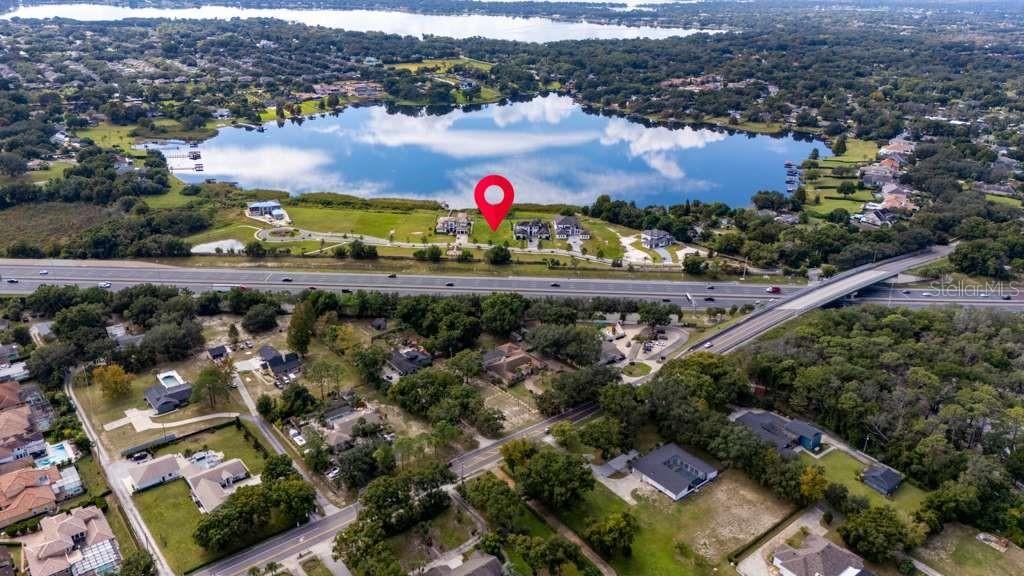An aerial view shows a lakefront property marked with a pin near a highway — 1330 LAKE OLIVIA, WINDERMERE, FL