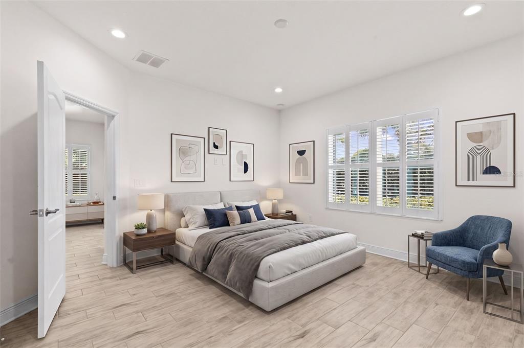 A bedroom with light wood-look tile floors, a bed, a blue chair, and plantation shutters — 13506 CIRCA CROSSING DRIVE, LITHIA, FL