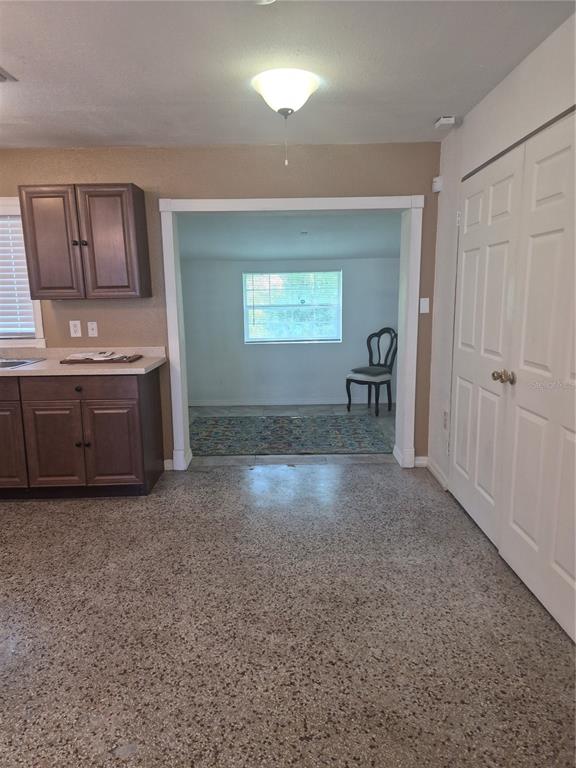 A small dining area with light-colored tile flooring and a single window on the back wall — 2103 MANTILLA AVENUE, ORLANDO, FL