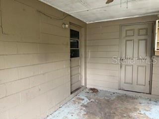 A single-story house with a white brick exterior and a covered front porch — 404 W LUTZ LAKE FERN ROAD, LUTZ, FL