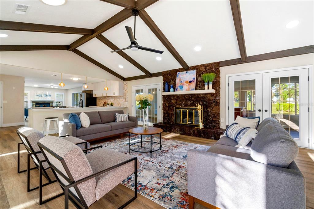 A dining room features a square table, woven chairs, a blue rug, and a chandelier — 5391 NW 76TH COURT, OCALA, FL