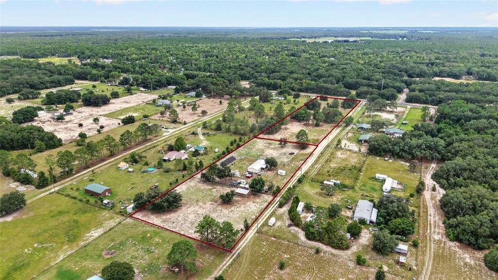An aerial view shows a rural property outlined in red, featuring several buildings and trees — 15355 SE 113TH STREET ROAD, OCKLAWAHA, FL