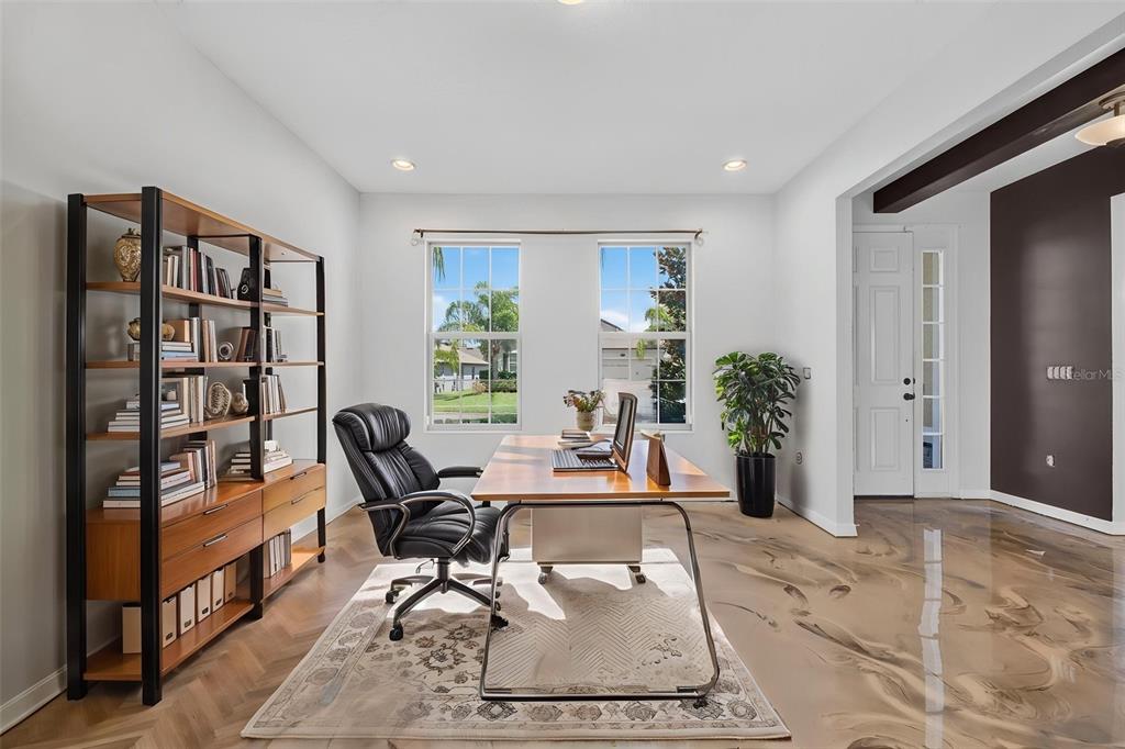 A home office features a wooden desk, a black leather chair, and a tall bookshelf — 2468 VERDE VIEW DRIVE, APOPKA, FL