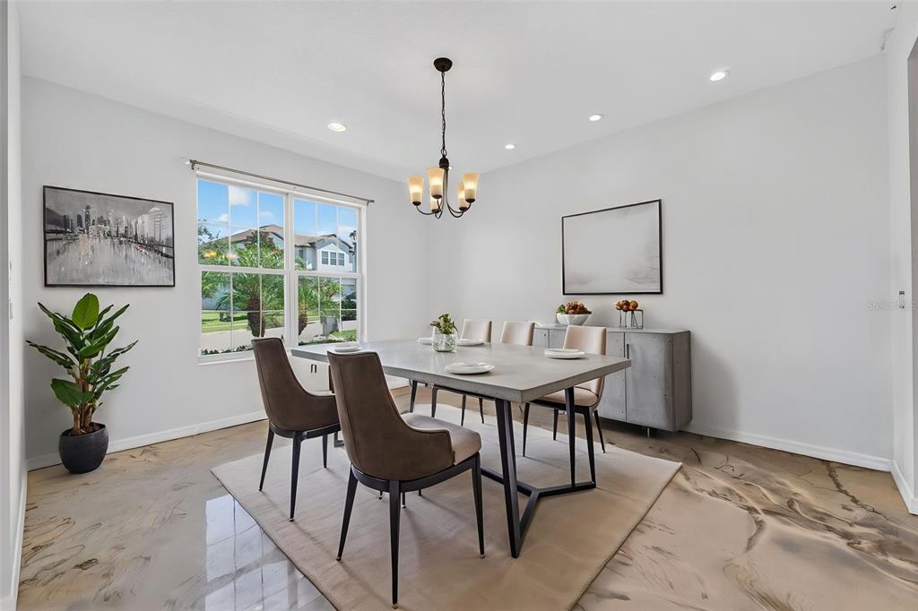A dining room features a concrete table, upholstered chairs, a chandelier, and glossy marbled flooring — 2468 VERDE VIEW DRIVE, APOPKA, FL