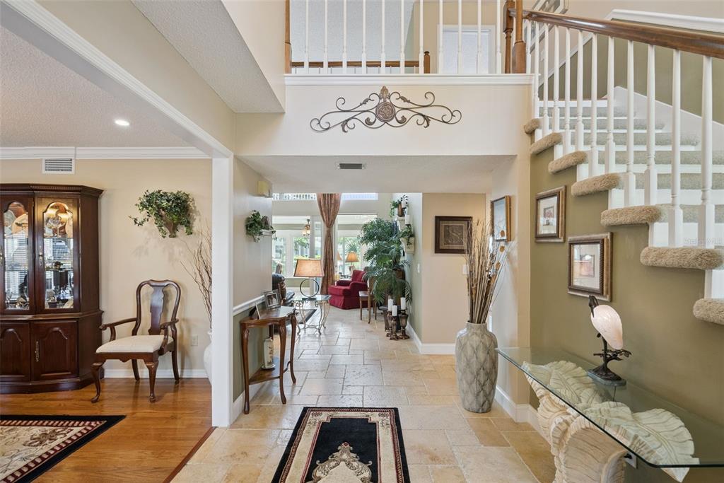 A foyer with tile flooring leads to a staircase and an open living area beyond — 236 S SHADOWBAY BOULEVARD, LONGWOOD, FL
