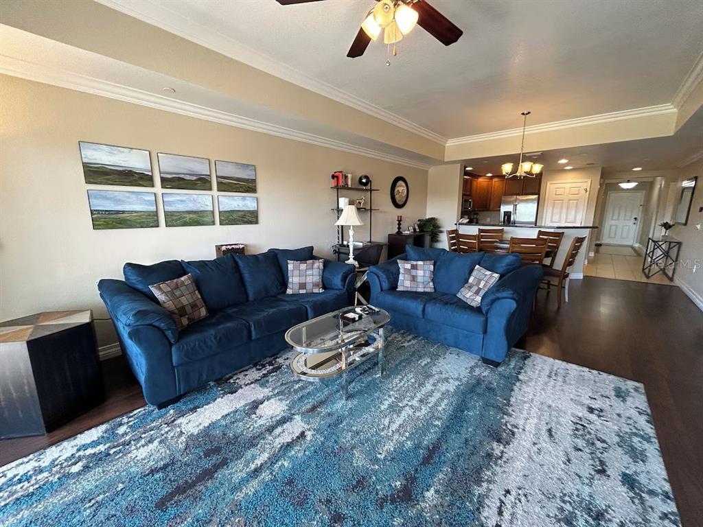 A kitchen features wood cabinets, granite countertops, stainless steel appliances, and a double sink — 7604 CABANA CT UNIT 303, REUNION, FL