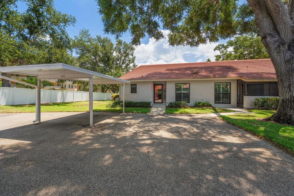 A single-story house with a carport, a red tile roof, and a paved driveway — 2069 LAKEVIEW DRIVE, CLEARWATER, FL