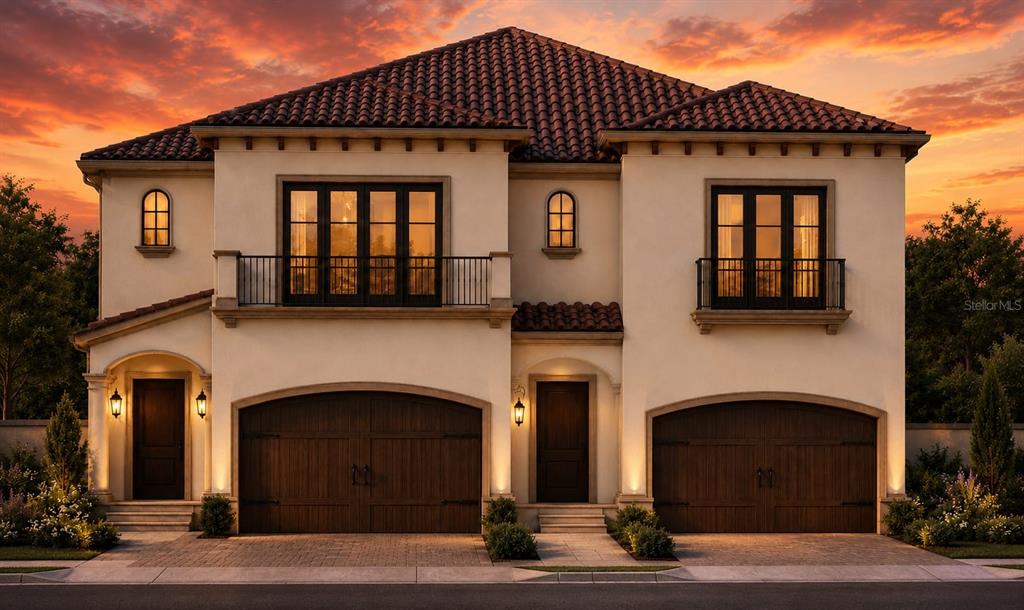 This is a rendering of a two-story Mediterranean-style duplex with two garages at sunset — 1964 FREEDOM DRIVE, CLEARWATER, FL