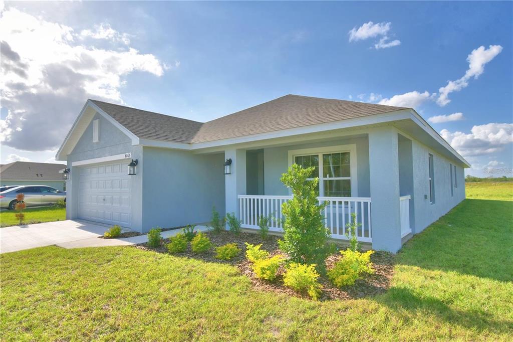 A light blue single-story house with a two-car garage and a small front porch — 3652 LINDBERGH STREET, LAKELAND, FL