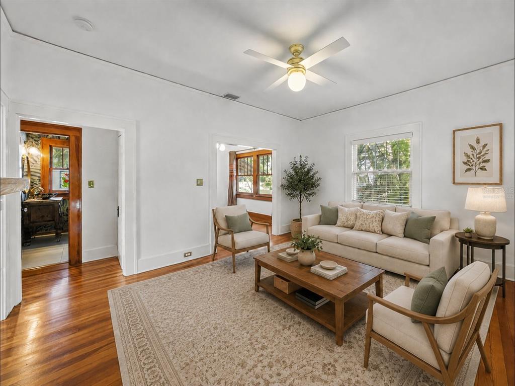 An empty room with hardwood floors, a ceiling fan, and a doorway to another room — 1024 23RD AVENUE N, ST PETERSBURG, FL