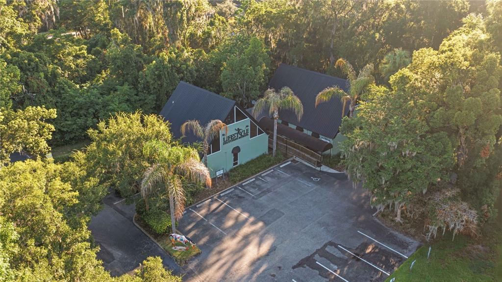 An aerial view shows a commercial building with a dark roof and a parking lot — 2139 NE 2ND STREET UNIT B1, OCALA, FL
