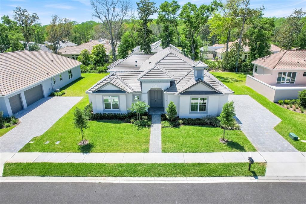 An aerial view of a single-story house with a gray tile roof and paved driveway — 132 NEW LEATHERWOOD DRIVE, PALM COAST, FL