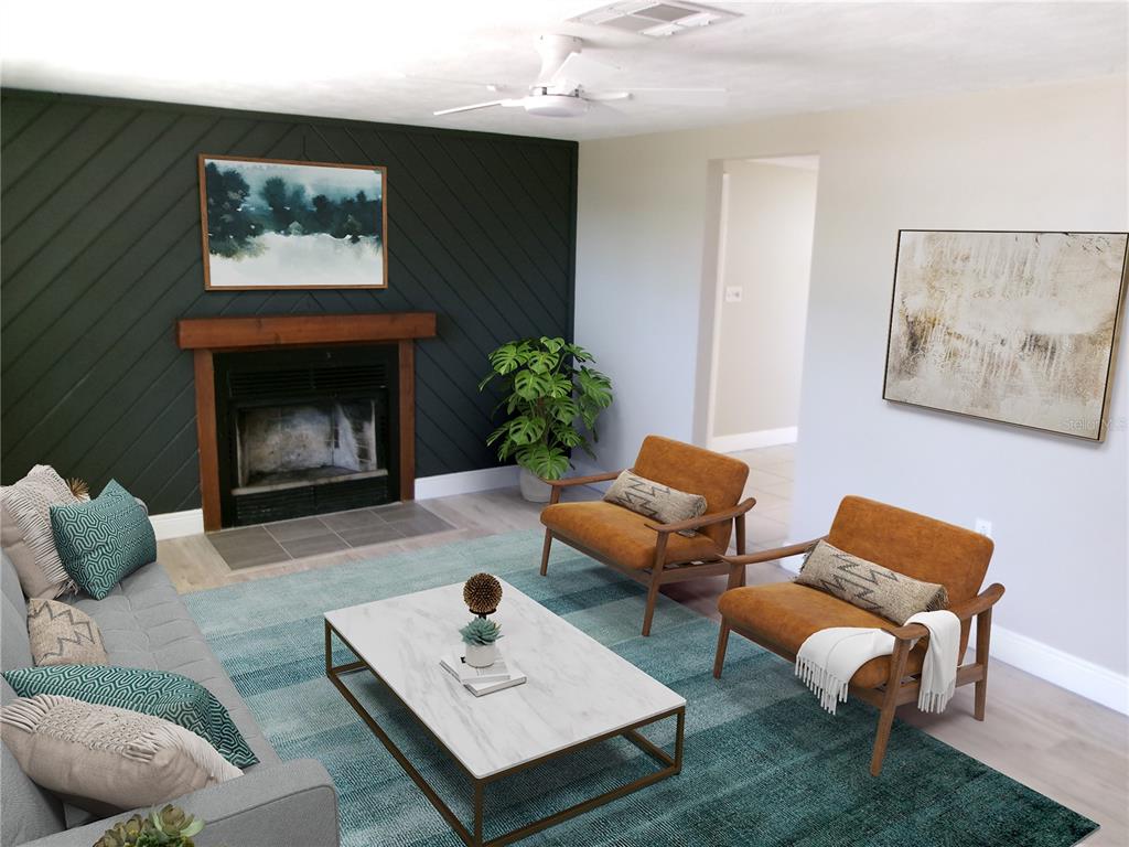 A living room features a dark green accent wall with a fireplace and two armchairs — 5103 VALIMOR DRIVE, HOLIDAY, FL