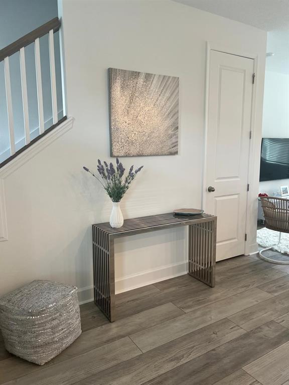 A modern entryway features a slatted metal console table, a textured ottoman, and wall art — 2252 CELEBRATION BOULEVARD, CELEBRATION, FL