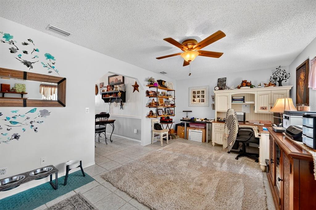 A room with tile flooring, a large area rug, a desk, and a ceiling fan — 2956 BRISTOL LANE, SOUTH DAYTONA, FL