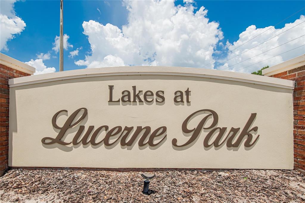 A beige monument sign for Lakes at Lucerne Park stands against a blue sky — 255 HAINES BOULEVARD, WINTER HAVEN, FL