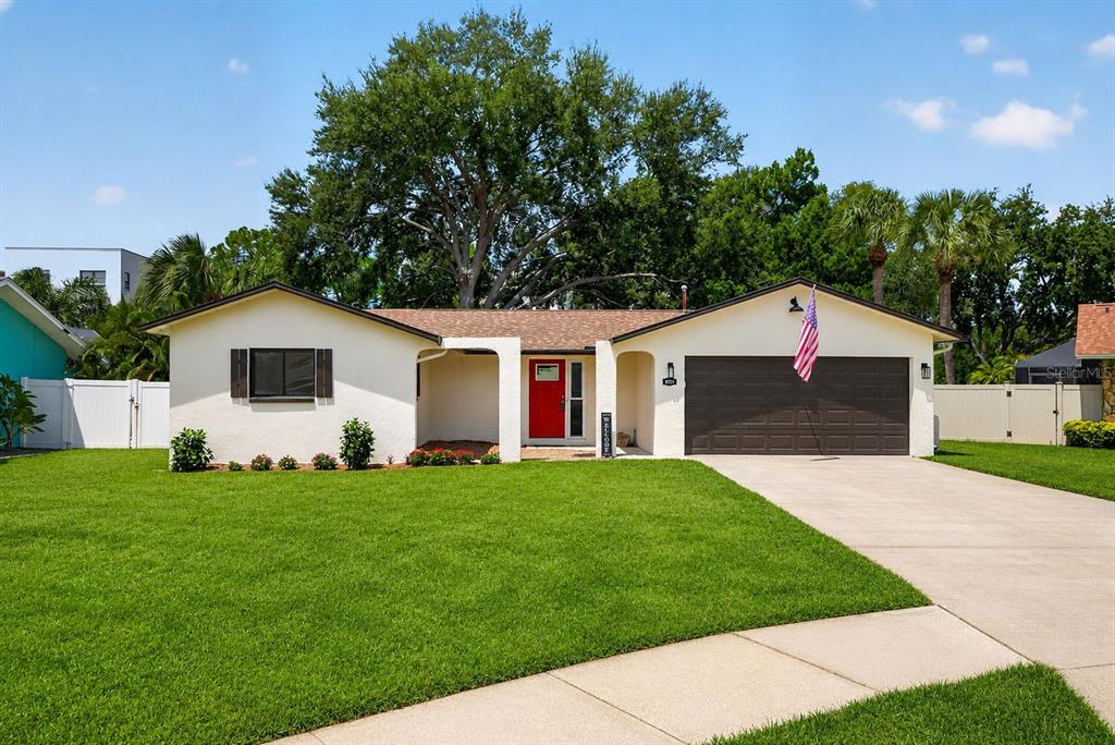 An aerial view shows a single-story house with a brown roof and a concrete driveway — 6170 SUNDOWN DRIVE, ST PETERSBURG, FL