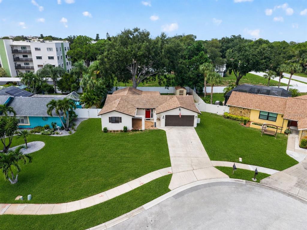 A red front door with a side light is centered on the exterior wall — 6170 SUNDOWN DRIVE, ST PETERSBURG, FL