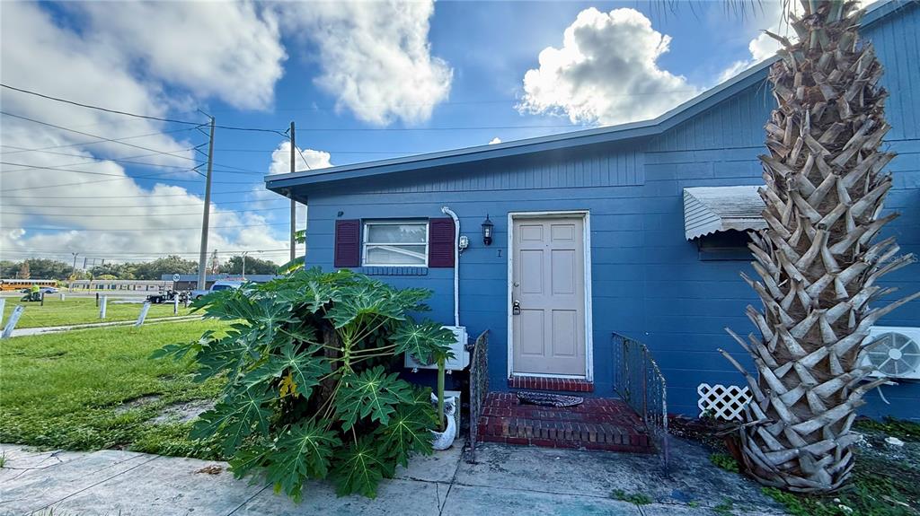 A kitchen features white cabinets, a granite countertop, stainless steel appliances, and tile flooring — 1310 N COMBEE ROAD UNIT 7, LAKELAND, FL