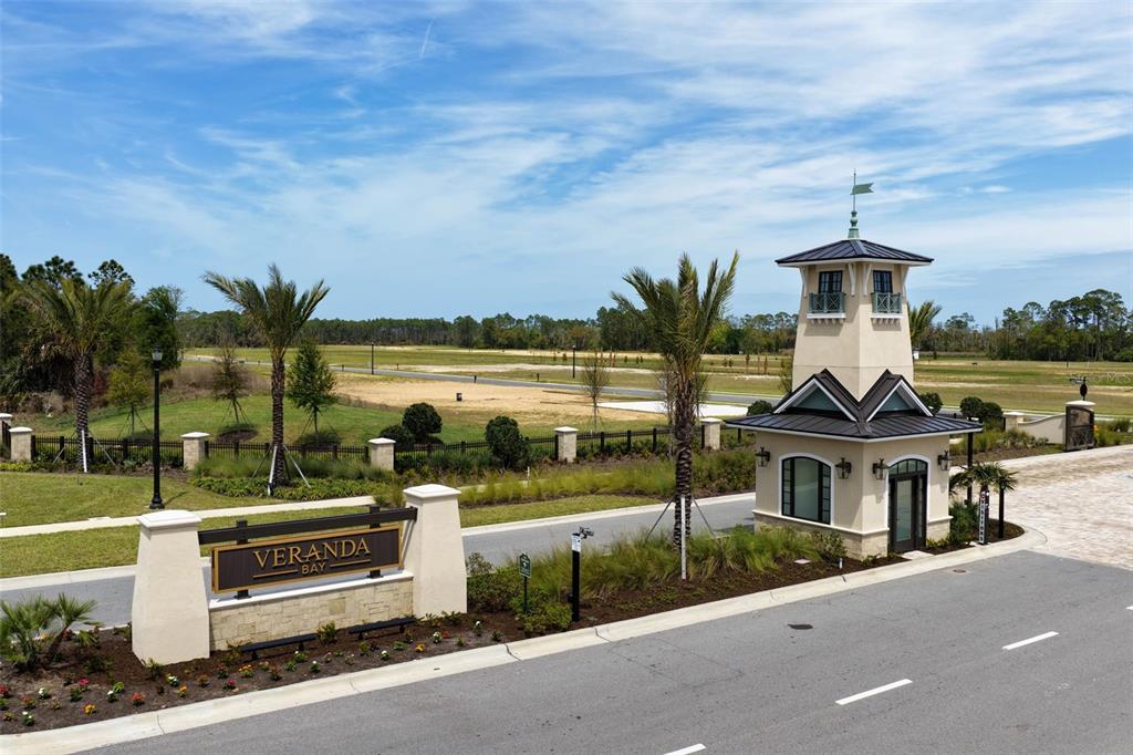 An entrance sign and a guardhouse stand at the gated entry of a residential community — 222 STILLWATER DRIVE, FLAGLER BEACH, FL
