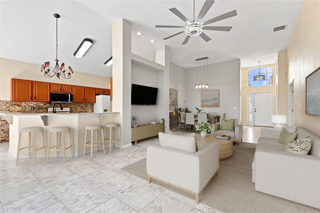 An open-concept living area features a kitchen with wood cabinets, a dining space, and tile flooring — 140 MOSS LN, DAVENPORT, FL