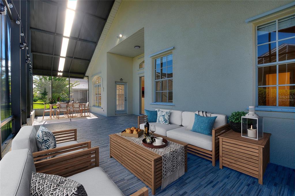 A covered patio features a seating area with wooden furniture, blue cushions, and tiled flooring — 140 MOSS LN, DAVENPORT, FL