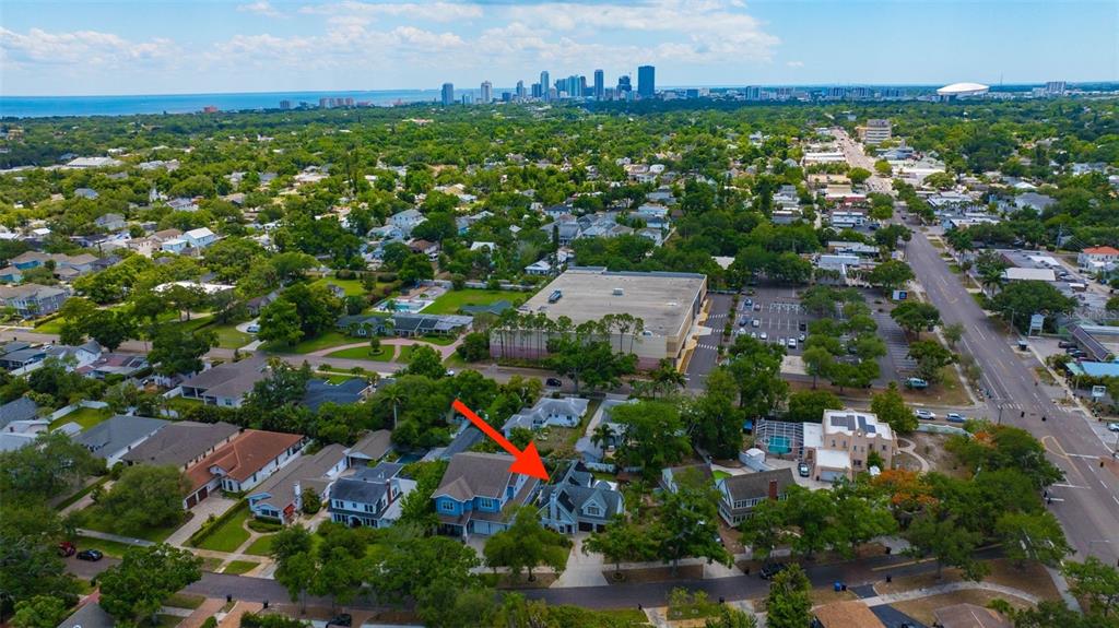 An open-concept kitchen and living area features tile flooring, a breakfast bar, and wood cabinetry — 852 35TH AVENUE N, ST PETERSBURG, FL