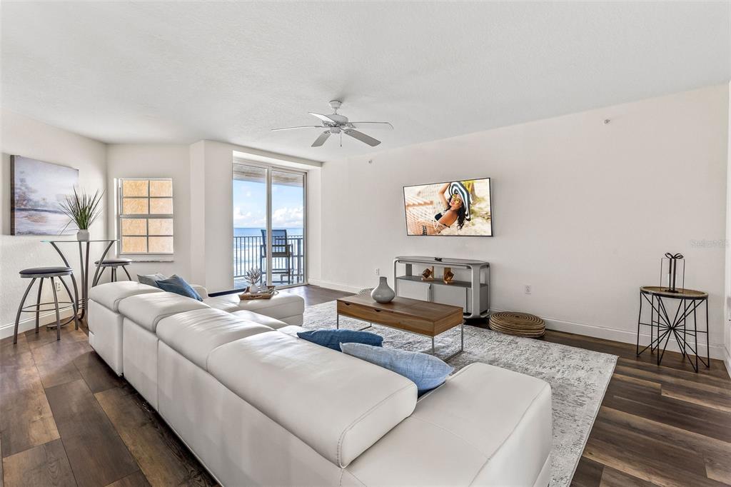 A balcony with tile flooring, patio furniture, and a view of the ocean and beach — 3145 S ATLANTIC AVENUE UNIT 405, DAYTONA BEACH SHORES, FL