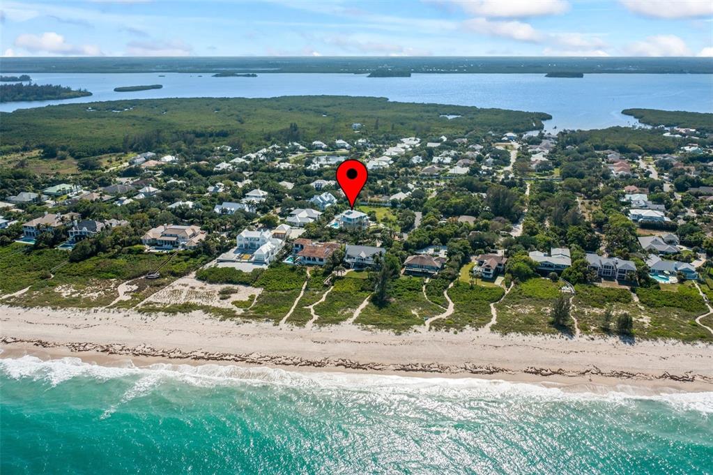 An aerial view shows a coastal neighborhood with a red location pin over a house — 2275 GENESEA LANE, VERO BEACH, FL