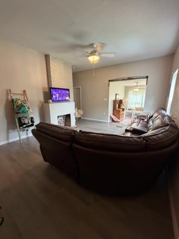 A living room features a brown sectional sofa, a white fireplace, and light wood flooring — 1003 NE 2ND STREET, MULBERRY, FL
