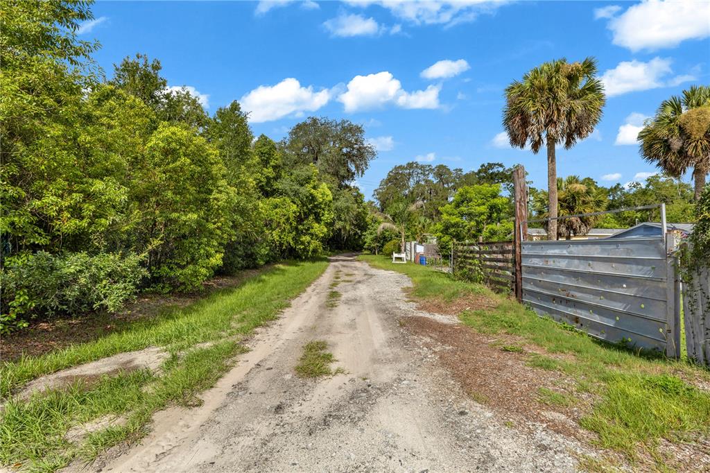 An aerial view shows a rural property with several houses and outbuildings outlined in red — 405 W SIMON AVENUE, APOPKA, FL