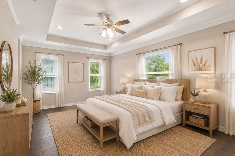 A staged bedroom features a king bed, tray ceiling, ceiling fan, and light wood furniture — 2704 W GRAY STREET UNIT A, TAMPA, FL