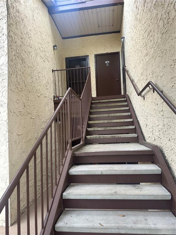 An outdoor staircase leads to two apartment doors on an upper landing — 763 MIDWAY DRIVE UNIT B, OCALA, FL