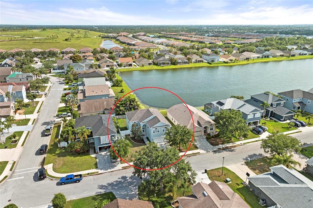 An aerial view shows a light-colored suburban house with a red circle highlighting it — 5224 58TH TERRACE E, BRADENTON, FL