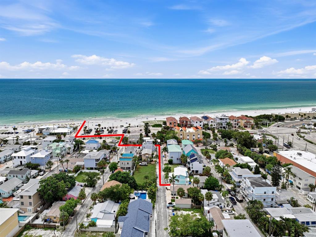 An aerial view shows a beachside neighborhood with a red line outlining a property boundary — 120 93RD AVENUE, TREASURE ISLAND, FL