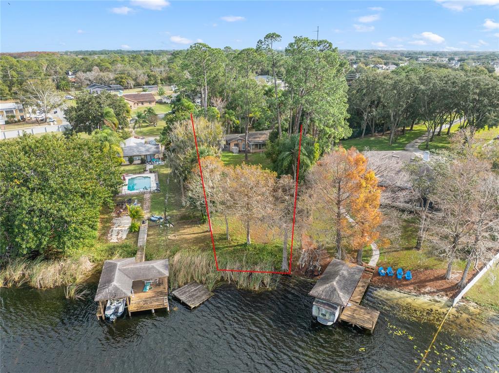 An aerial view of a waterfront lot with a boat dock and mature trees — 3658 N ECONLOCKHATCHEE TRAIL, ORLANDO, FL