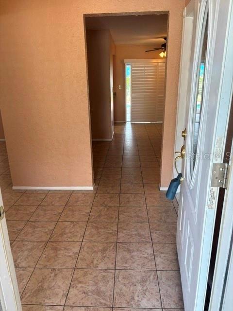 A view from an open front door into a tiled entryway leading to a living area — 2230 BIRCHBARK TRAIL, CLEARWATER, FL