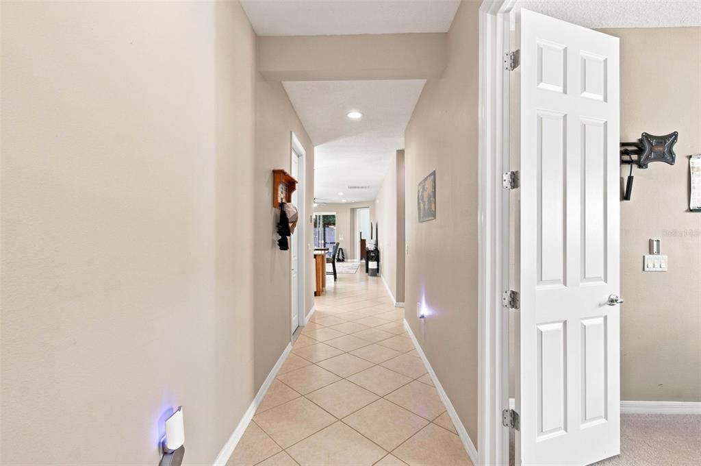 A tiled hallway leads from a doorway toward an open-concept living area — 1055 HARBOR RIDGE DRIVE, KISSIMMEE, FL