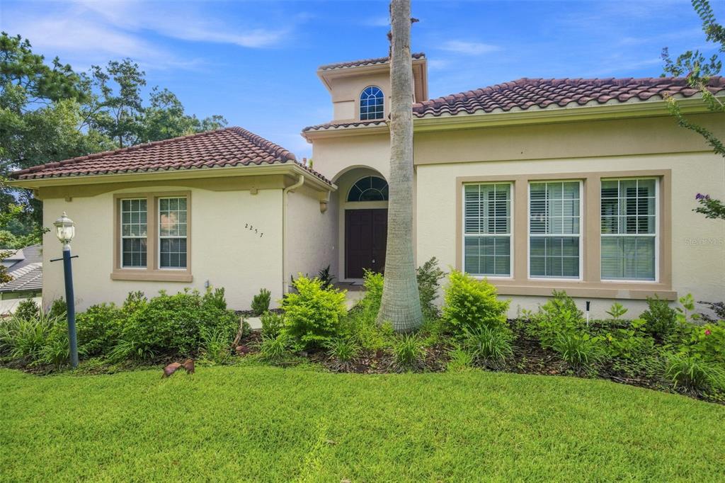 A single-story house with a tile roof, stucco exterior, and a central arched entryway — 2257 N HICKORY GLEN POINT, HERNANDO, FL
