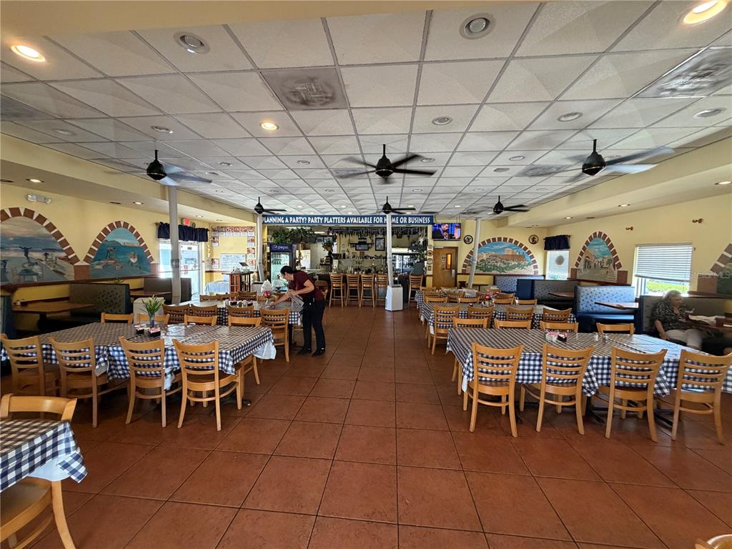 The interior of a restaurant features tiled floors, drop ceilings, and multiple dining tables — 1501 CLEARWATER LARGO ROAD N, LARGO, FL