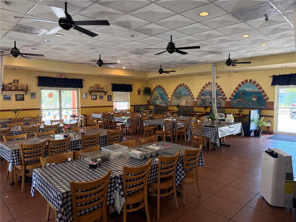 A restaurant dining room features checkered tablecloths, ceiling fans, and arched wall murals — 1501 CLEARWATER LARGO ROAD N, LARGO, FL
