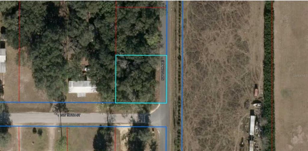 This aerial map shows a vacant, wooded lot outlined in blue near a street intersection — Lot 112 NW 70TH AVENUE, TRENTON, FL